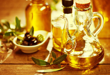 Olives and virgin olive oil on the wooden table