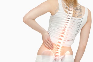 Highlighted spine of woman with back pain - obrazy, fototapety, plakaty