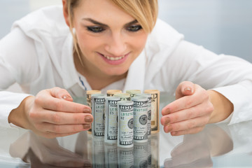 Businesswoman With Rolled Dollar Banknote