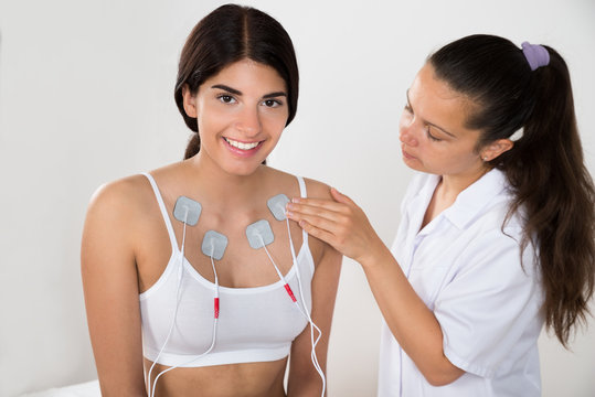 Happy Woman Getting Electrodes Therapy