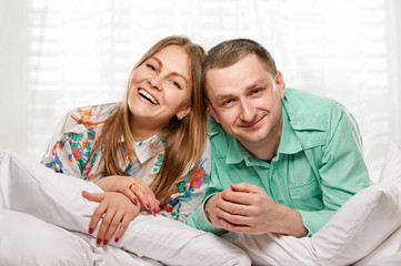 Couple lying in bed smiling