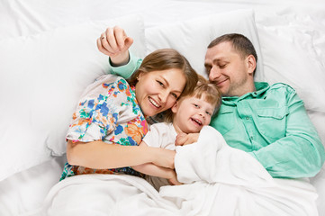 Fototapeta premium Happy mother and the father with cute daughter