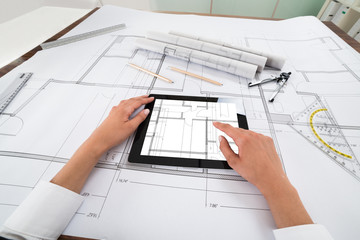 Naklejka na ściany i meble Architect With Digital Tablet Over Blueprint