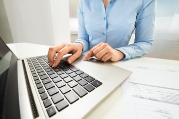Businesswoman Typing On Laptop Keyboard