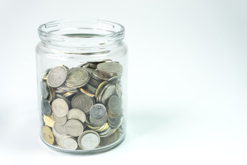 Isolated coins in jar - financial concept.