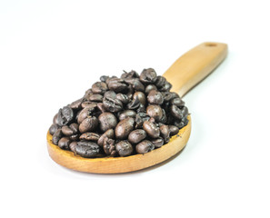 Coffee beans on a wooden ladle