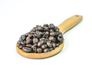 Coffee beans on a wooden ladle