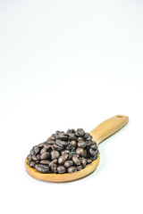 Coffee beans on a wooden ladle