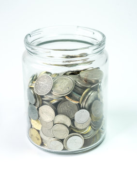Isolated coins in jar - financial concept