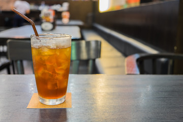 Glass of iced lemon tea on table