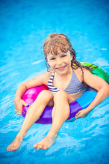 Child playing in swimming pool