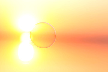 bubble flies over the water at sunset
