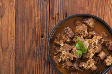 Beef stew - wooden background