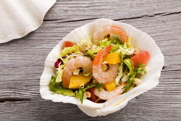Shrimp salad with grapefruit, orange and roasted peanuts. - Serv