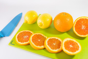 Knife And Slices Of Oranges And Lemon
