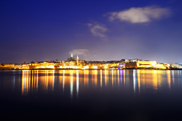 The panorama of Valletta in night illumination, Sliema, Malta