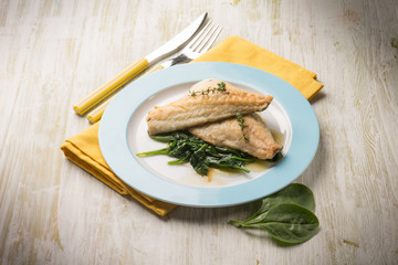 fish fillet with fresh spinach