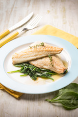 fish fillet with fresh spinach