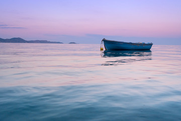 Lonely traditional greek fishing boat on sea water