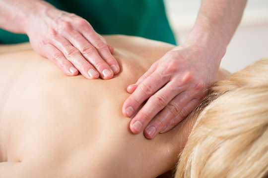 Stressed woman having back massage