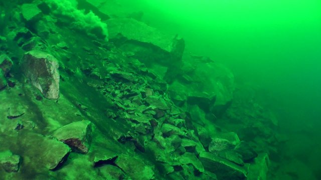 Underwater Avalanche On A Rocky Slope, Wide Shot.
