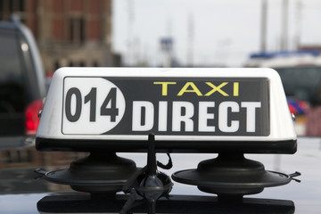 Taxi sign on a cab at the central station in amsterdam