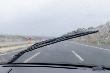Fototapeta na wymiar wipers on the windshield of the car in the rain