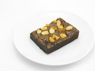 Chocolate brownie on a white plate in white background.