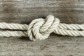 old texture of wooden boards with rope and knot