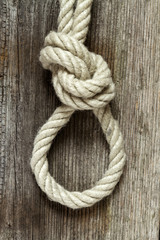 old texture of wooden boards with rope and knot