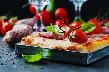 Pizza with salami and tomato