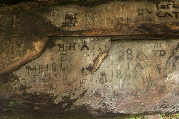 Carved graffiti. St Cuthbert's Cave. Northumbrland. England. UK.