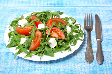 healthy salad of arugula, cheese and tomato 