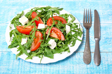 healthy salad of arugula, cheese and tomato 