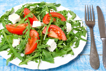 healthy salad of arugula, cheese and tomato 