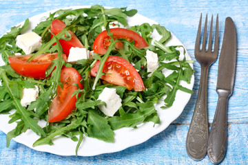 healthy salad of arugula, cheese and tomato 