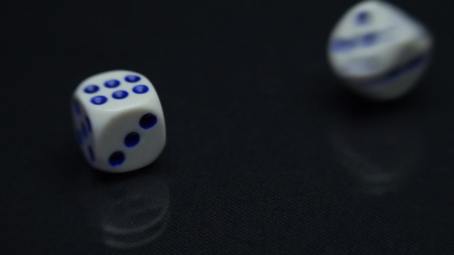 White dice on a black background