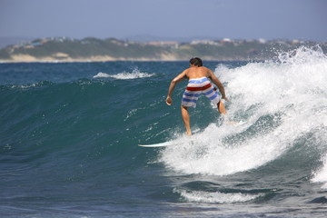 Adrenaline seeking surfer surfing in the ocean