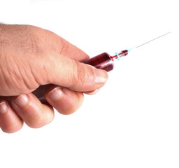 Studio shot of an hand holding a syringe