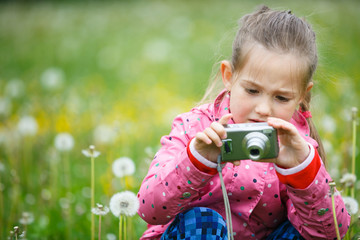 Little girl photographing with her camera