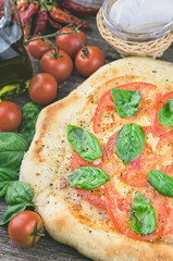 Rustic italian pizza with mozzarella, cheese and basil leaves