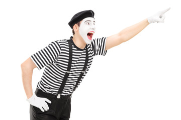 Mime artist pointing up with his hand
