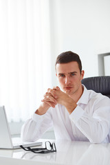 Business man working in an office with a laptop