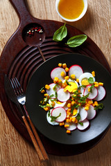 Obraz na płótnie Canvas easy summer salad: radishes, eggs, corn.