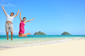 Happy fun tourists couple jumping Beach vacation