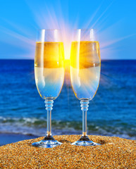 Glasses with champagne near the sea