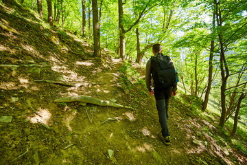 Teenager hiker walking on a mountain trail