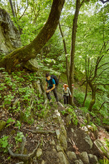 Family of hikers walking on a mountain trail