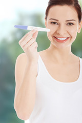 Happy woman with pregnancy test. 