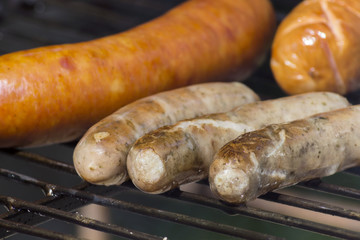 slow smoked vide types of sausages on the grill